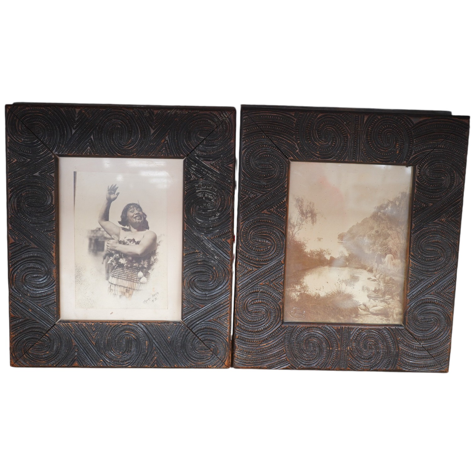 A pair of Maori carved wood photograph frames containing contemporary New Zealand photographs c.1900-10, carved in relief with rauponga lines and spirals, inset with contemporary albumen photos, depicting figures by Waik